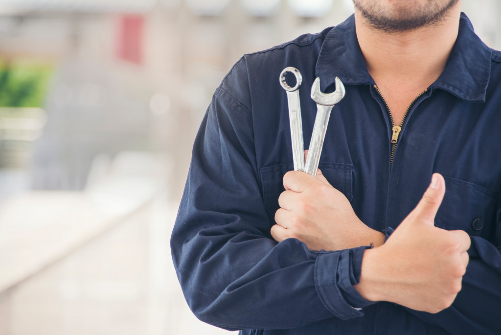 man holding wrenches