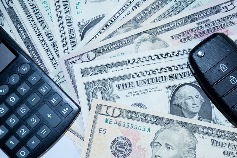 a calculator, cash, and a car key